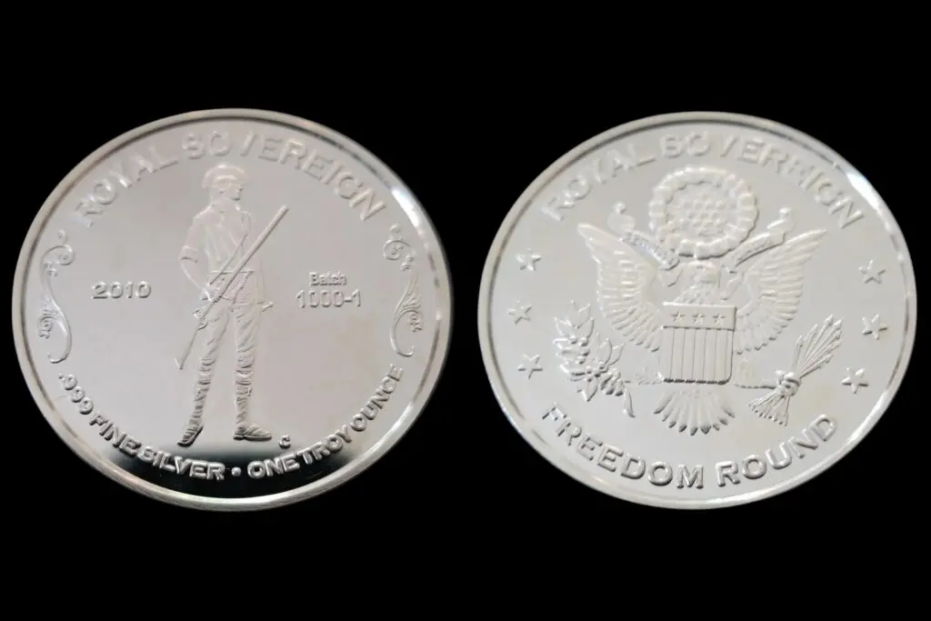 A silver coin with the image of an american soldier.