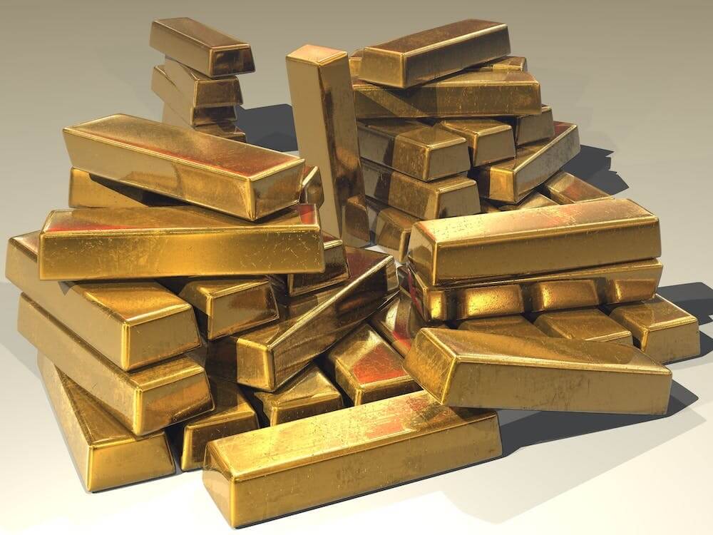 A pile of gold bars sitting on top of each other.